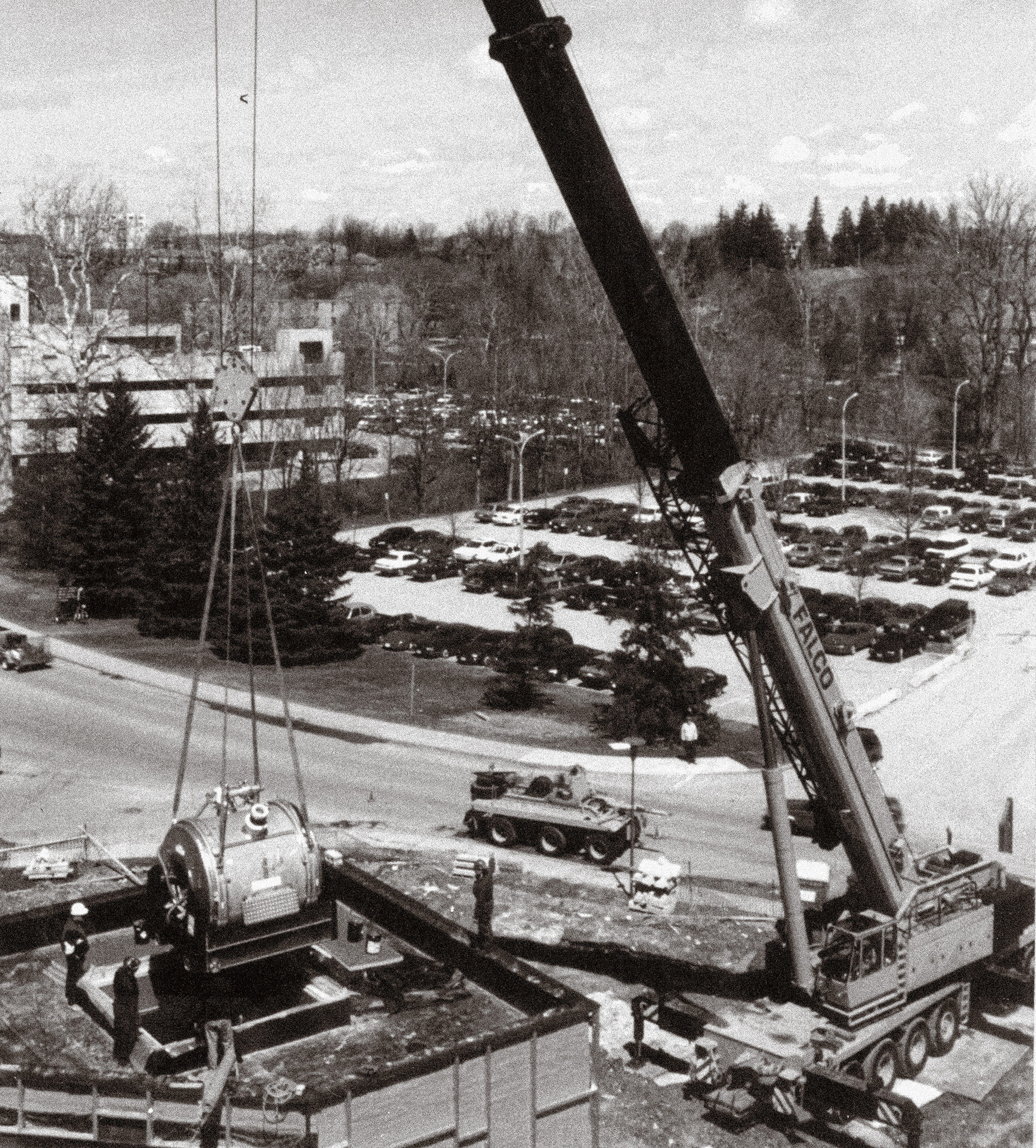 Archival photo of a crane lowering the 4 Tesla MRI magnet into the Centre for Functional and Metabolic Mapping, April 1996